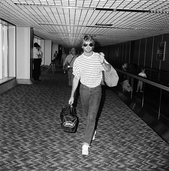 George Michael arriving at Heathrow airport from Los Angeles where he has been on holiday
