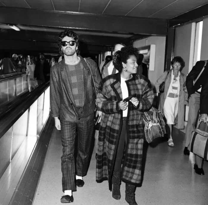 Framed Print : George Michael of the pop group Wham!, and girlfriend Pat Fernandez at London airport