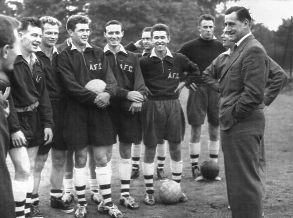 George Swindin, ex-Arsenal keeper and now Manager, talks to his team at a pre-season