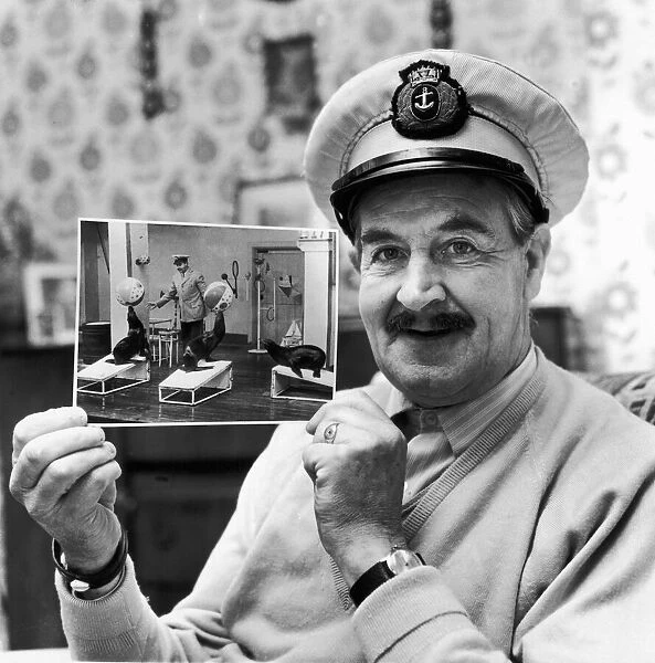 George Wilburn 'Captain George'the sealion trainer at Belle Vue holds a