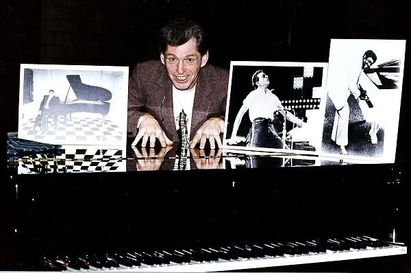 Georgie Fame singer behind grand piano with photograhs
