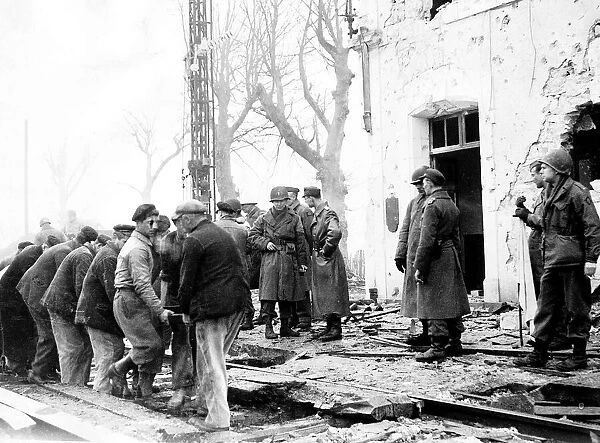 German American and French officers watch workmen replace the railway lines so that