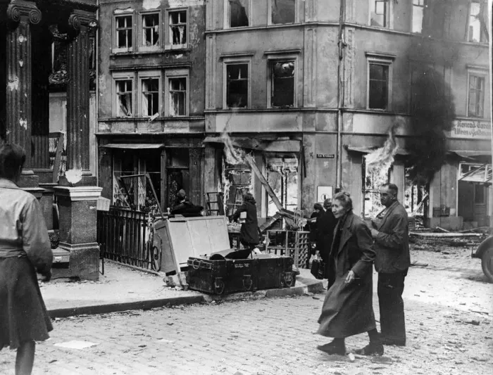 Framed Print : German civilians hurry past a burning building in Bamberg