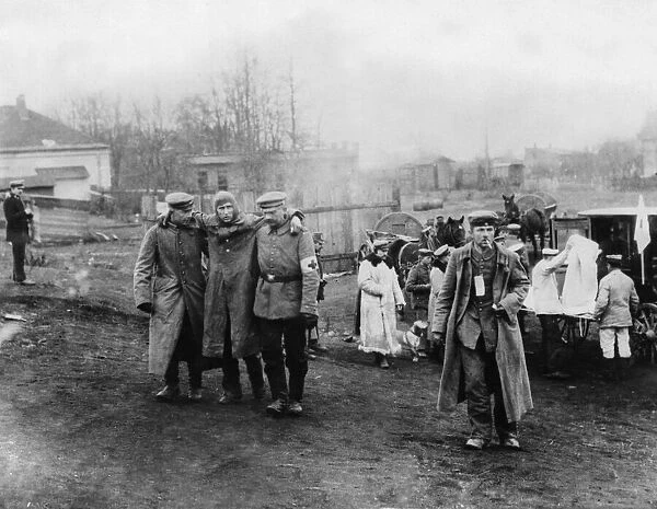 German Red Cross workers near Lowicz, Poland help an injured German pilot to a field