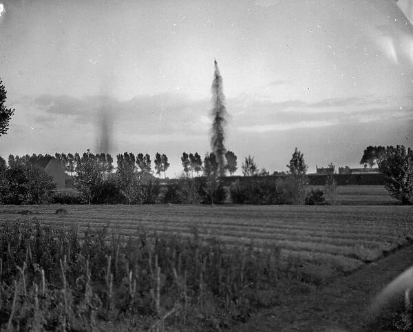 German shells bursting in the great reservoirs at Waelhem close to Antwerp