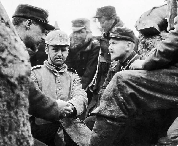 A German soldier captured by the Belgian troops is given medical treatment to an injured