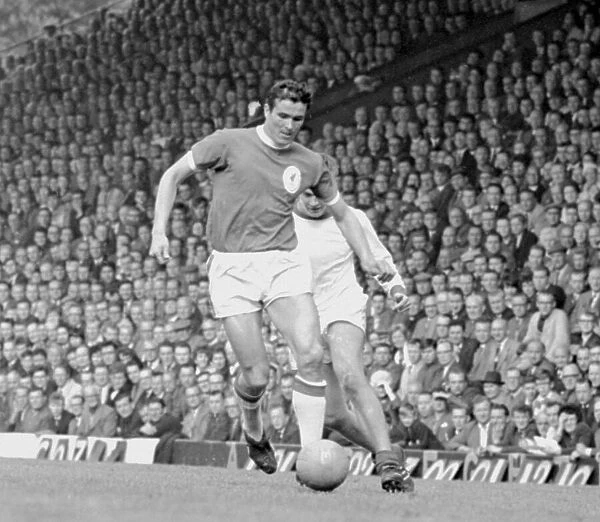 Gerry Byrne of Liverpool is chased for the ball by Terry Anderson of Arsenal during