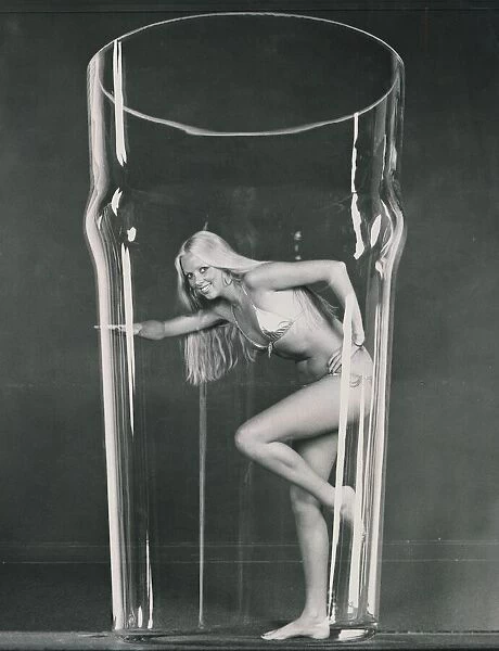Girl in a bikini inside a large beer glass Circa 1972