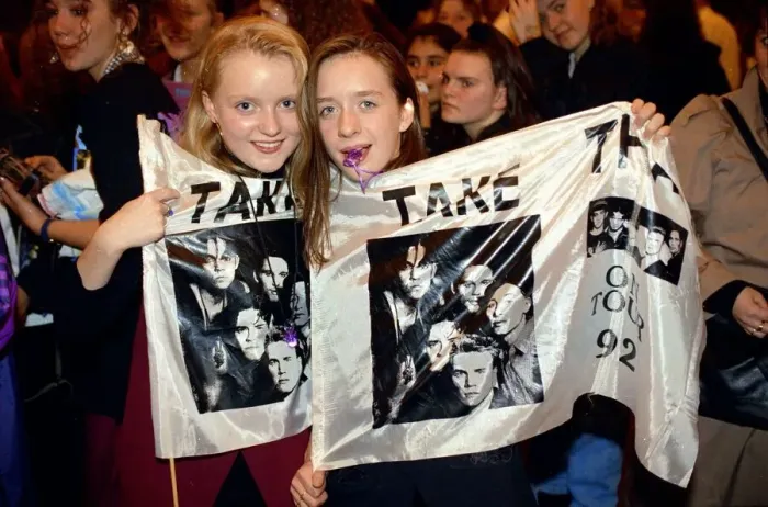 Framed Print : Girl fans of pop group take That holding a flag with the group Framed Print : Girl fans of pop group take That holding a flag with the group