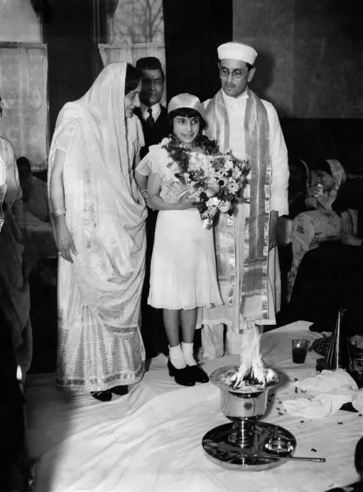Framed Print : Girl with priest and parents in front of fire symbol during confirmation