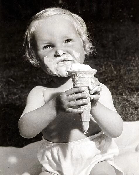 This girl is really enjoying her ice cream. Circa 1950