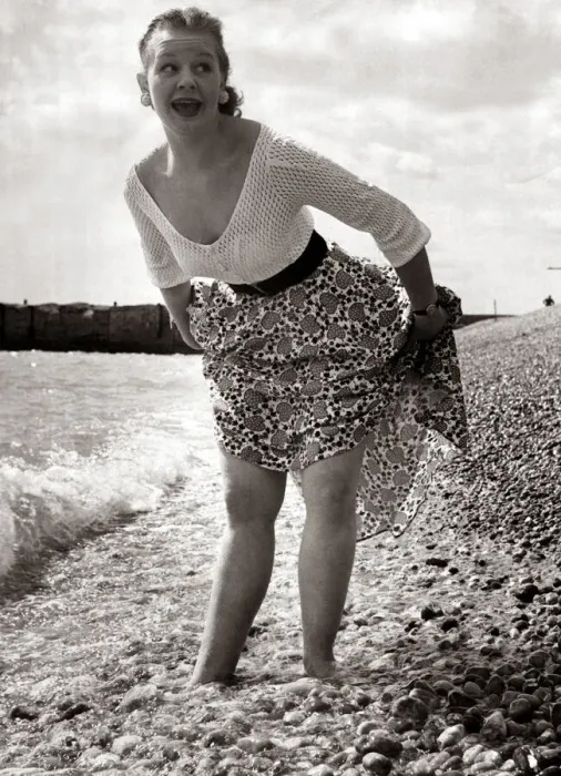 Framed Print : A girl wearing a flowery skirt and white top as she paddles in the waters of a shingle Framed Print : A girl wearing a flowery skirt and white top as she paddles in the waters of a shingle