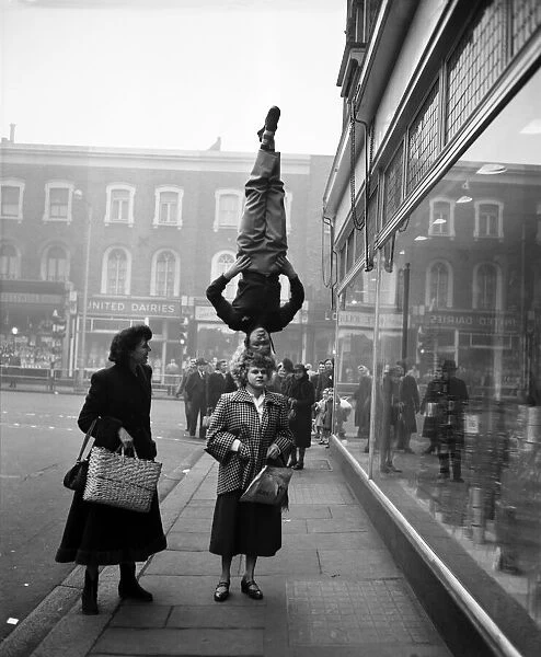 Two girls from the Chaludis act perform in the street at Hammersmith, London