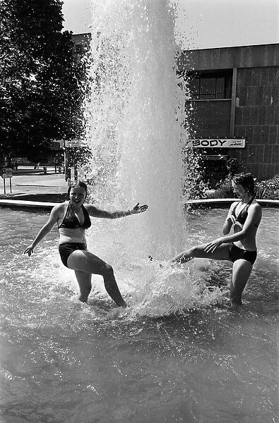 Two girls cooling off in the Belgrade Fountain, Coventry. 3rd July 1976