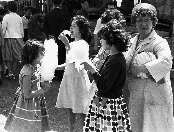 Girls eating candyfloss at Hearsall Common fair, Coventry. 3rd June 1967