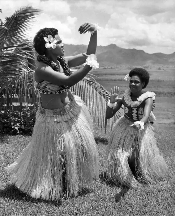 Framed Print : Two girls in grass skirts against a background of palms, flowers and mountains Framed Print : Two girls in grass skirts against a background of palms, flowers and mountains