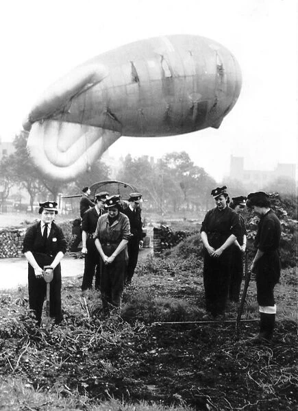 Girls on a north west of England balloon barrage site join in morning prayers. WW2 1942