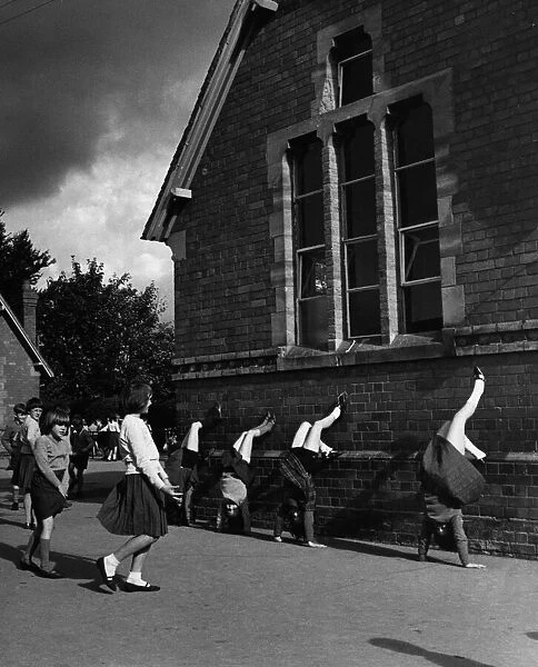 Girls playing in a school yard. 18th October 1965
