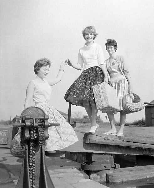 Three girls preparing for a picnic along the side of the canal at Perry Barr