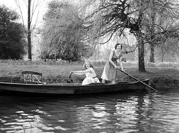 Two girls in a rowing boat on a trip on the river Circa 1954