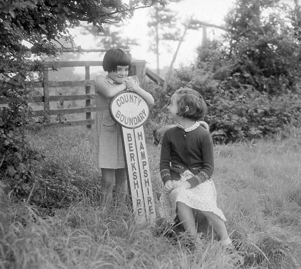 Two girls standing on the county boundary between Berkshire and Hampshire