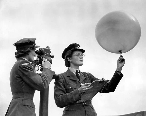 Girls of the WaFs with the theodolite and balloon for meterological observation at an