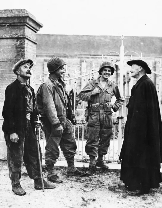 Framed Print : Two GIs chat with a French peasant and the padre of a church near Nueilly, France. P