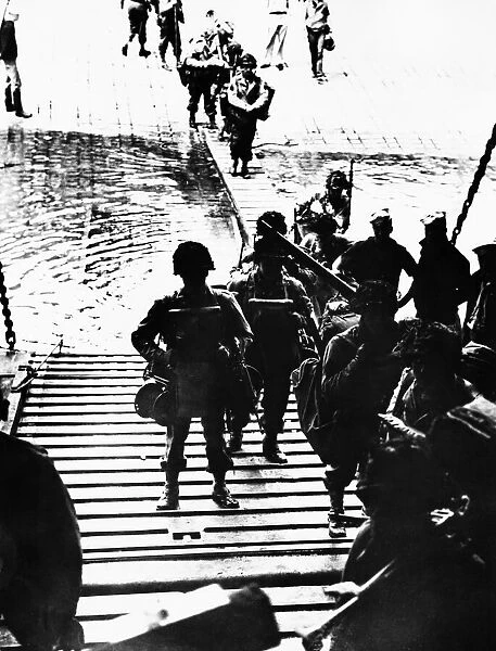 GI.s (with equipment) entering landing craft during WWII. 6th June 1944