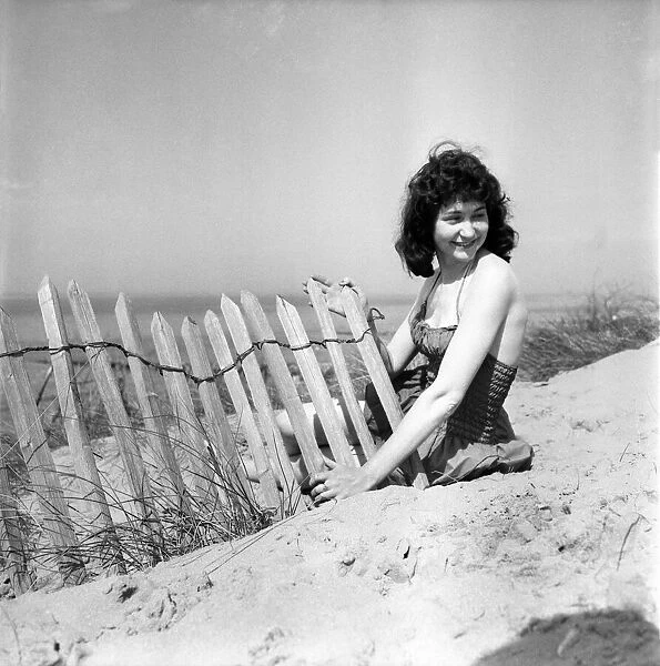 Glamour Girl. Barbara Stockton, 19 seen here posing on the beach. June 1960 M4295-001