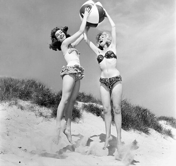 Glamour girls Marion and Jean Collins on the beach. June 1960 M4323-007