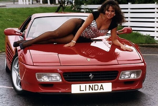 Glamour Mmodel Linda Lusardi sits on the bonnet of Ferrari 512TR. 2nd October 1993