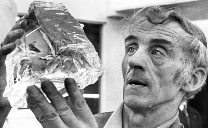 Framed Print : Glass blower Mr. John Gartland examines a chunk of quartz which will be turned into a