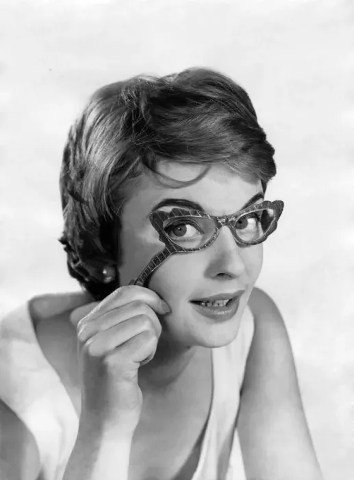 Framed Print : Glasses fashions. Model wears hand-held glasses. December 1957 P018651