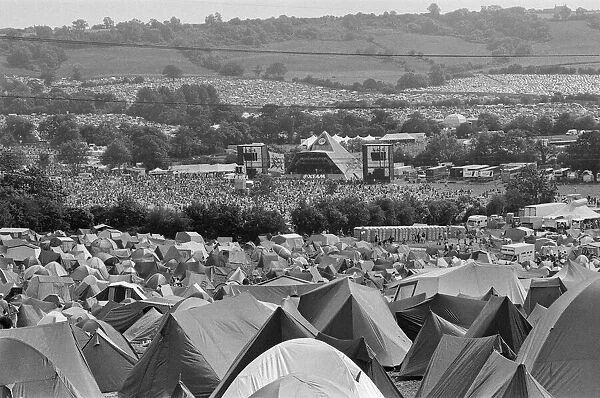 Glastonbury Festival, Pilton, Somerset. Picture shows scenes from the 1993 festival. Hundred of tents and thousands of people enjoy the music from The Pyramid Stage seen in the distance