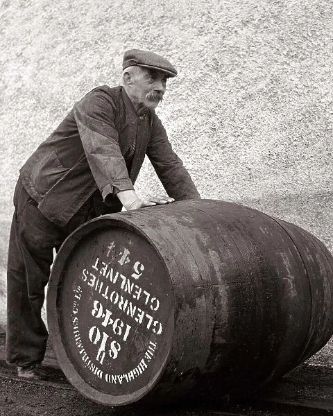 A Glenlivet Distillery worker in Scotland rolls a barrel of their finest single malt