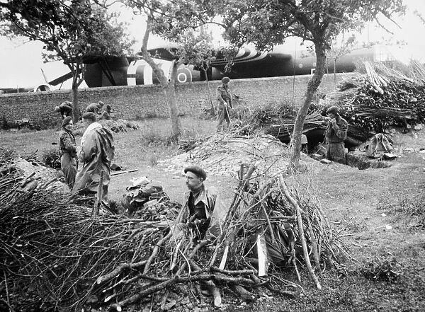 Gliders troops dig positions ahead of a field in which they were landed