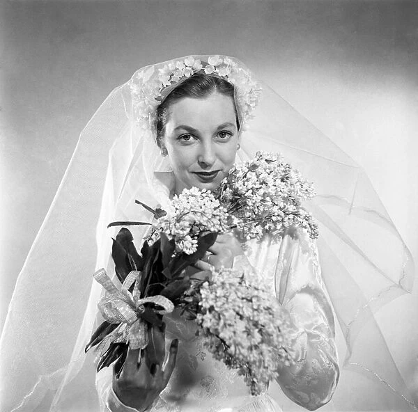Gloria clarry seen here modeling a wedding dress. March 1953 D1281