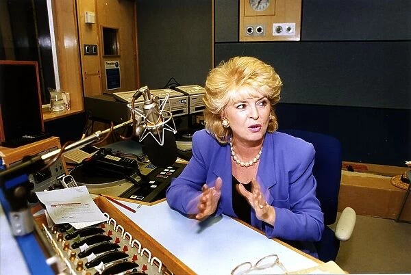 Gloria Hunniford TV and Radio Presenter sitting at a desk in a Radio Studio