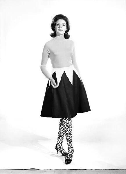 Gloria James modelling a skirt that can convert to a cape. 1962 B1848-002