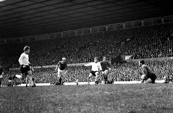 Goal scoring chance for Manchester United as Bobby Charlton rushes towards goal during