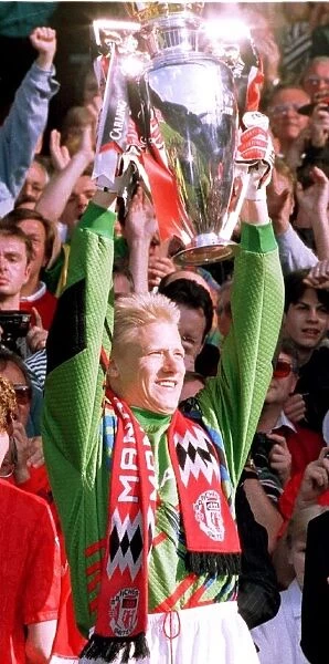 Goalkeeper Peter Schmeichel holds the Carling Premierhip Trophy won by Manchester United