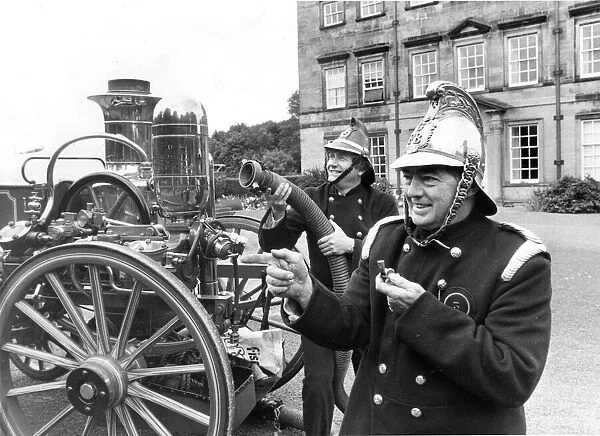 Goeff and Robin dressed as Victorian Firefighters with a fire engine of that era at