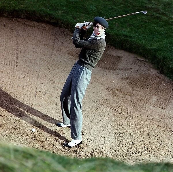 Golf Fashion female golfer in bunker grey trousers