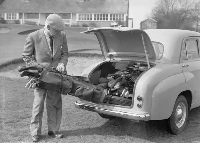 Framed Print : Golfer seen here storing his golf clubs in the boot of his brand new Standard 8 car Circa