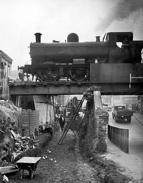 A goods train makes its way across the tow bridge in the centre of Stourbridge as it is