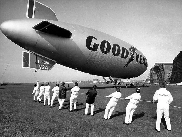 The Goodyear Europa airship is hauled into position by teams of men at RAF Cardington