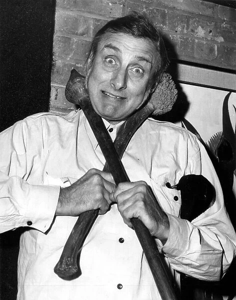 Former Goon Spike Milligan is pictured with two aboriginal weapons at