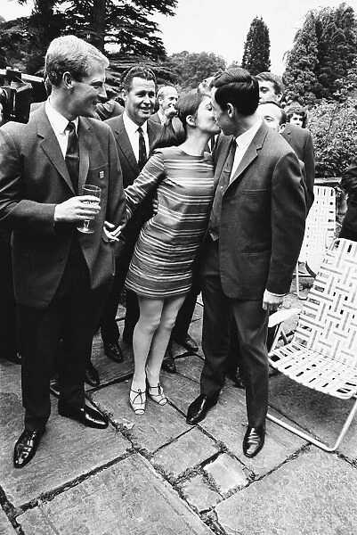 Gordon Banks gives a kiss to actress Vivienne Ventura watched by Ron Flowers during