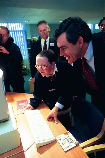 Gordon Brown is shown around the computer room at Benfield School by pupil Claire