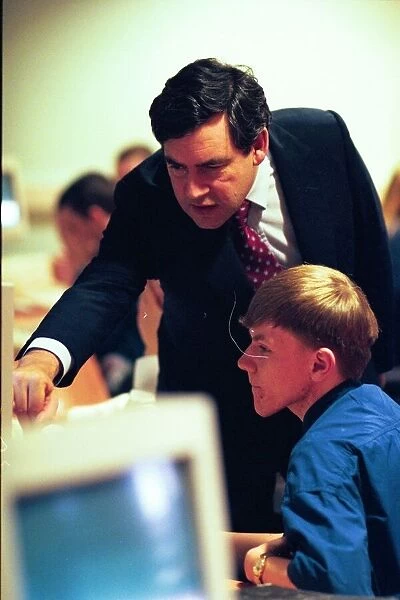 Gordon Brown is shown around the computer room at Benfield School by pupil Claire